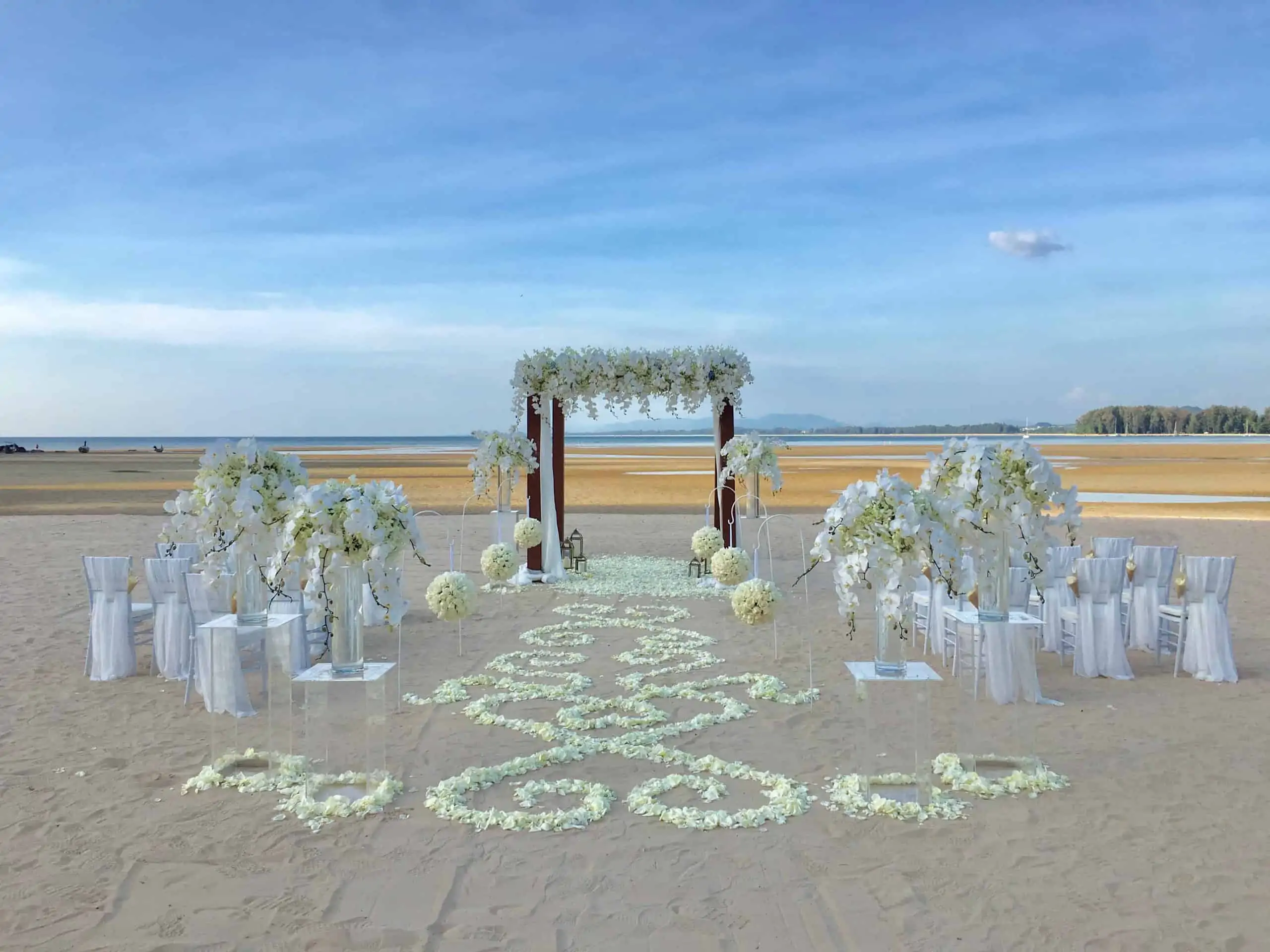 Aerial view of a luxury private-villa wedding ceremony in Phuket with fairy-light canopy and floral altar by Wedding Flowers Phuket