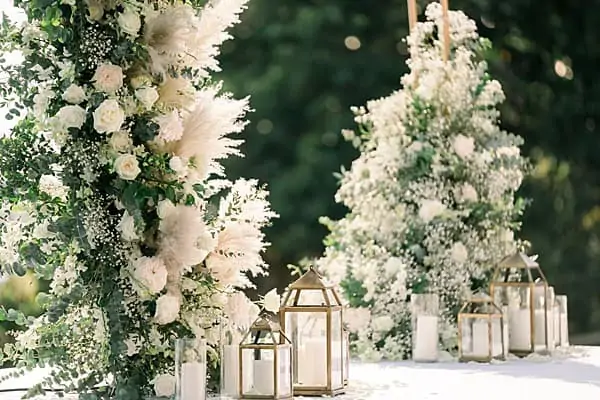 Editorial restraint — pampas, white floral arch and lantern detail by Wedding Flowers Phuket